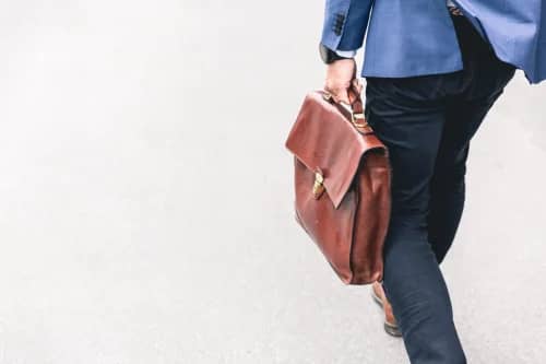 Businessman carrying suitcase - Seven Seas digital